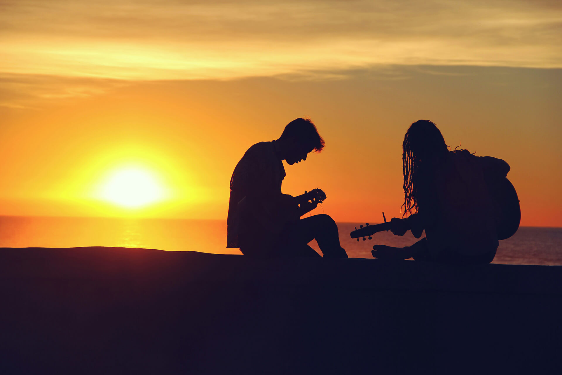 Two musicians on the beach